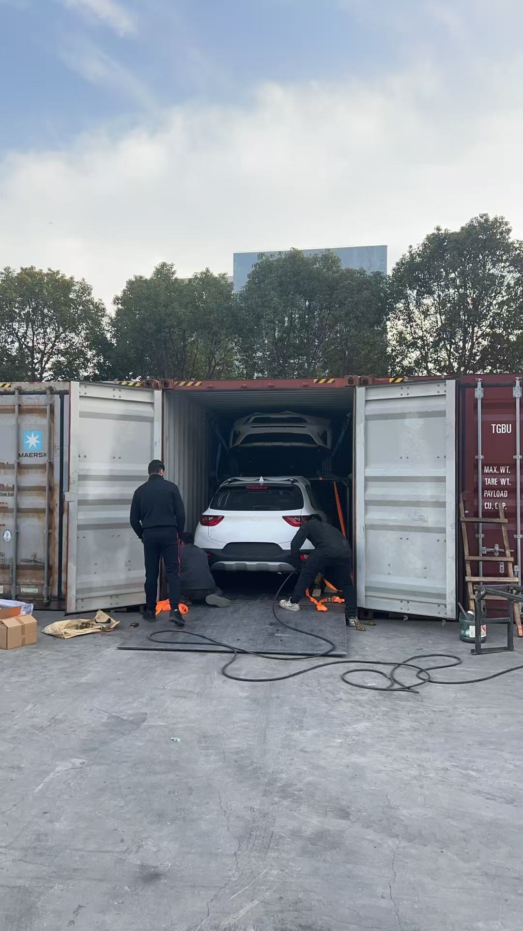 Car being loaded into shipping container